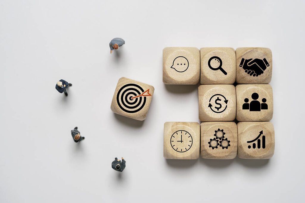 Four business people standing and consider with dartboard icon for review business achievement objective target and goal concept.